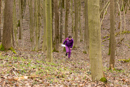 Grodno, Belarus - 26 March, 2023: Cute young caucasian women wearing sportswear running through a...