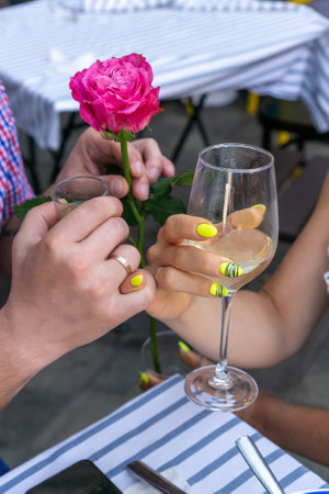 The hands of a man and a woman celebrating their wedding anniversary. An original toast in which a couple grapples with their little fingers.の写真素材