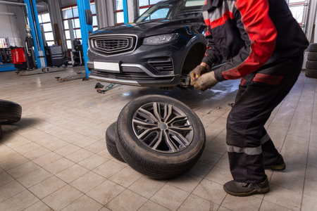 Working inside tire service center. Replacing rubber on car wheels. Car tire service center auto...