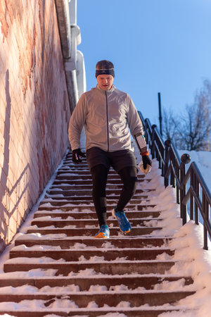 Grodno, Belarus - January 03, 2024: Young man participates in winter orienteering training in urban conditions. Outdoor orienteering check point activityのeditorial素材