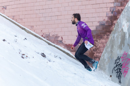 Grodno, Belarus - January 03, 2024: Young man participates in winter orienteering training in urban conditions. Outdoor orienteering check point activityのeditorial素材