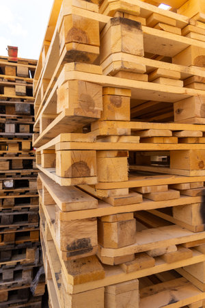 Piles of stacked natural wooden shipping pallets. Outside a big stack with big stack of wooden pallets.の写真素材