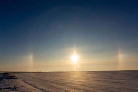 Winter landscape with circular halo phenomena around the sun in form of colored rings in Grodno, Belarus.の写真素材