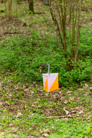Orienteering. Control point Prism and electric composter for orienteering in the spring forest. Navigation equipment. The conceptの写真素材