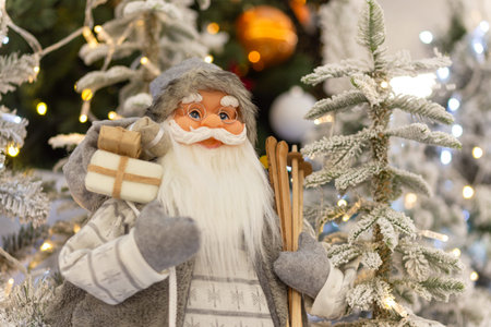 A Christmas installation with Santa at the foot of a festively decorated Christmas tree in the big...