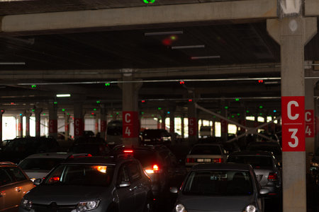 Neon multi-level underground parking in a shopping center. Covered, underground car parking.の写真素材