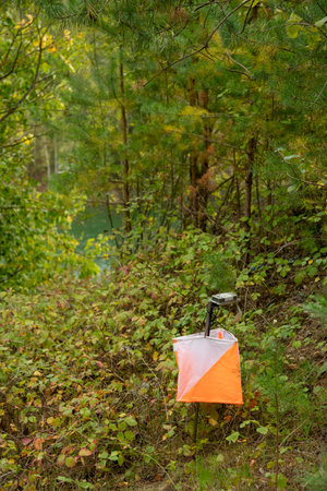 Orienteering. Control point Prism and electric composter for orienteering in the spring forest. Navigation equipment. The conceptの写真素材