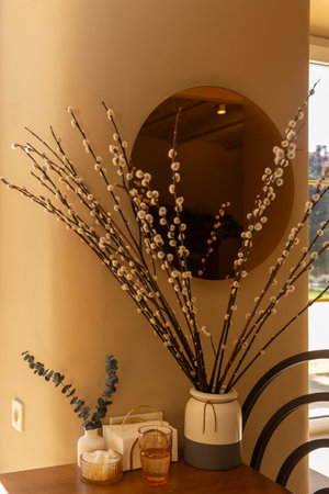 A napkin holder and a vase with a flower on a wooden table in a trendy coffee shopの写真素材
