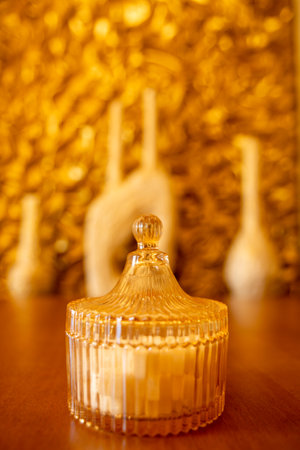 A charming sugar bowl sits on a cafe table bathed in warm morning light, surrounded by a delightful atmosphere, perfect for starting the day with a sweet touch.の写真素材