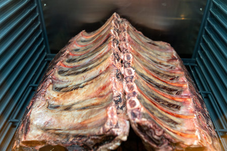 Marbled beef dry aging lies in the refrigerator in a restaurant. Dry aged beef meat, dry-aged hanged...