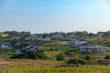 View of newly built modern suburban houses in a quiet residential area. Real estate development in the suburbs.の写真素材