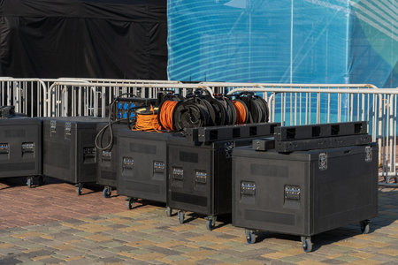 Equipment boxes on music stage for LED screen assembly. Cables, panels, parts ready for outdoor...