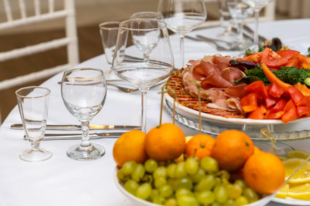 Platters with assorted meats and fruits on a festive table setting for a holiday celebration or...