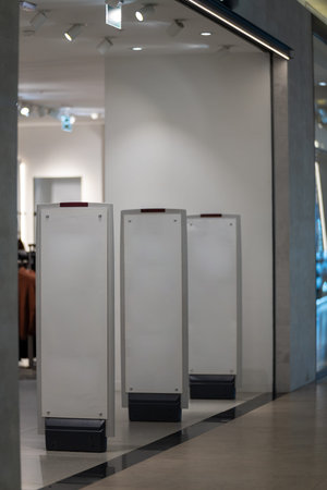 Radio-frequency security gates with integrated metal detector at a clothing store entrance, a modern...