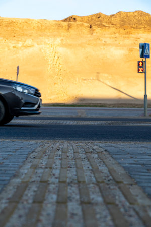 Traffic lights on red signal at a crosswalk on a sunny day.の写真素材