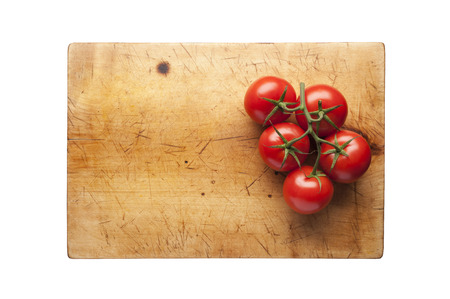 Fresh tomatoes on cutting boardの写真素材
