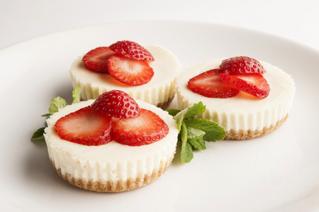 Three cheese cakes on white plate close upの写真素材