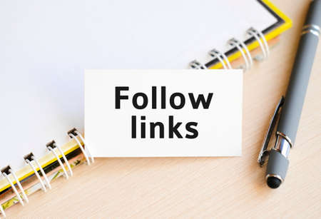Follow links - text on a notebook with a spring and a gray penの写真素材