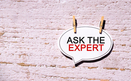 Ask the Expert on a white sheet with wooden pins
