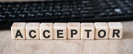 Acceptor - concept text on wooden cubes and in the background black keyboardの写真素材