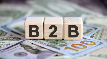 Financial acronym B2B. Business concept on cubes and dollarsの写真素材