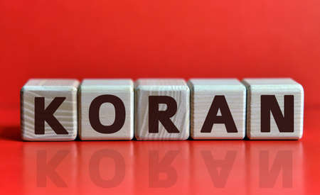 KORAN - holy book, text on wooden cubes on red backgroundの写真素材