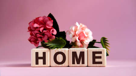 Home page concept on wooden cubes and flowers on the backgroundの写真素材
