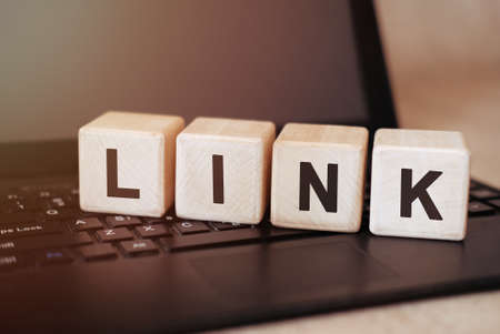 Rank - marketing concept on wooden cubes on laptopの写真素材