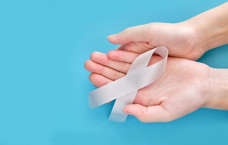 Silver symbolic ribbon - the problem of neurological diseases, Parkinson's disease, ovarian cancer,...