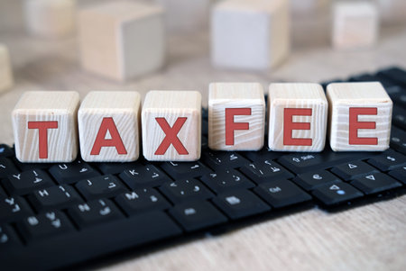 Tax and Fee text on cubes lying on the keyboard