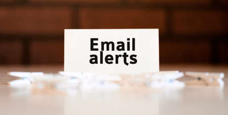 Email alerts text of business concept on white list and with clothespinsの写真素材