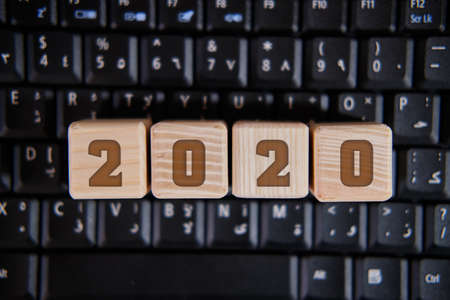 2020 on cubes, on a black keyboardの写真素材