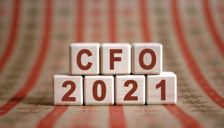 CFO 2021 text on wooden cubes on a monochrome background with reflection.