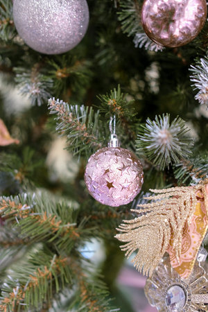 Christmas tree, Christmas balls, decorations with decorative toys, bows and ribbons with selective focusの写真素材