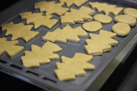 Dough in the form of a Christmas tree figure, baking in the ovenの写真素材