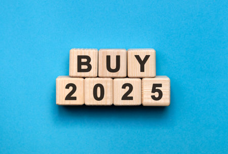 Numbers 2025 and text on cubes on a blue backgroundの写真素材