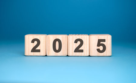 Numbers 2025 on cubes on a blue backgroundの写真素材
