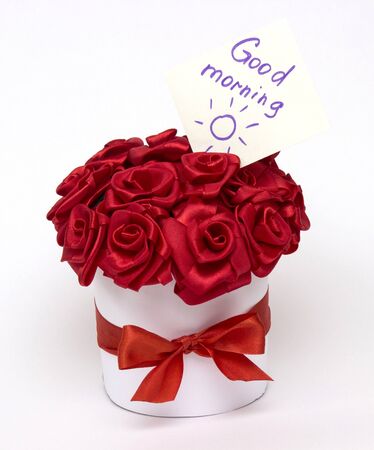 A bouquet of red roses made from satin ribbon with an inscriptionの写真素材