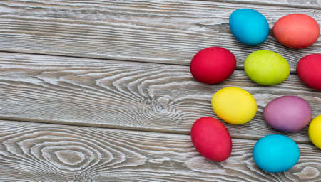 Multicolored easter eggs on vintage painted wooden backgroundの写真素材