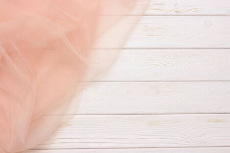 Beautiful layers of gentle pink background with tulle fabric on a wooden backgroundの写真素材