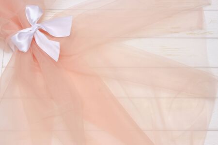 Beautiful layers of gentle pink background with tulle fabric on a wooden backgroundの写真素材