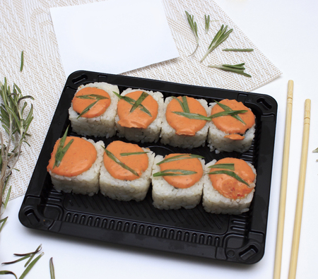 Sushi on plate with chopsticks. Sushi roll japanese food in restaurant.の写真素材