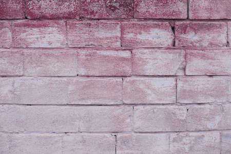 Texture of old brickwork with a pinkish faded painted surfaceの写真素材