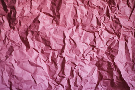 Uniform bright festive background, in pink shades, created from crumpled paperの写真素材