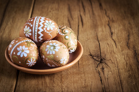Easter eggs with ornament on the wooden background tintingの写真素材