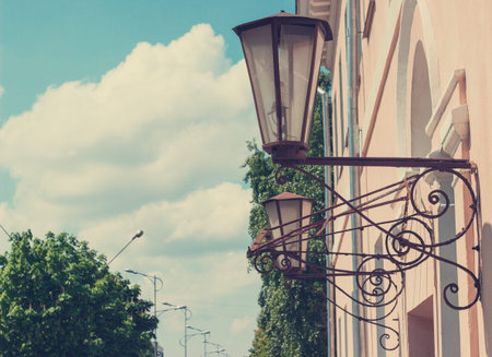 Street lamps on a building wall retro forging toningの写真素材