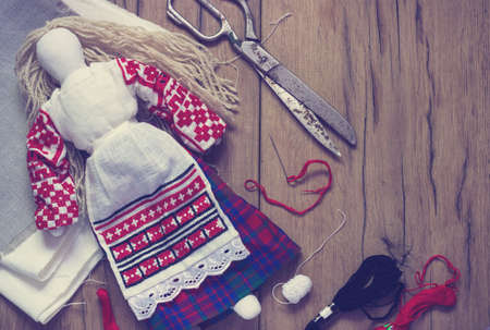 Belarusian traditional doll  production on a wooden background toningの写真素材