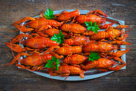 crawfish on wooden background in a plateの写真素材