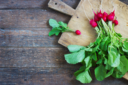 Fresh radishes on old wooden table bundle