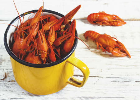 crawfish on wooden white background in metal mugの写真素材